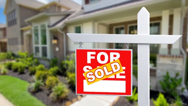 For sale sign with sold sticker over it