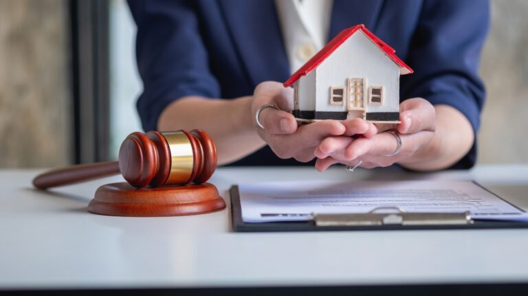 lawyer holding wooden model of house