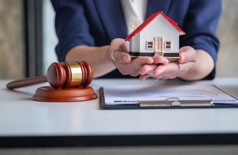 lawyer holding a wooden model of a house