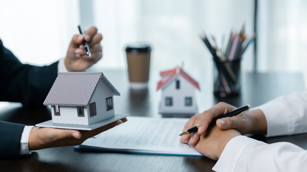 Real eastate lawyer is showing house model to the client