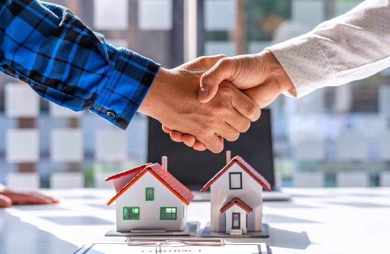 Real estate lawyer and client shake hands